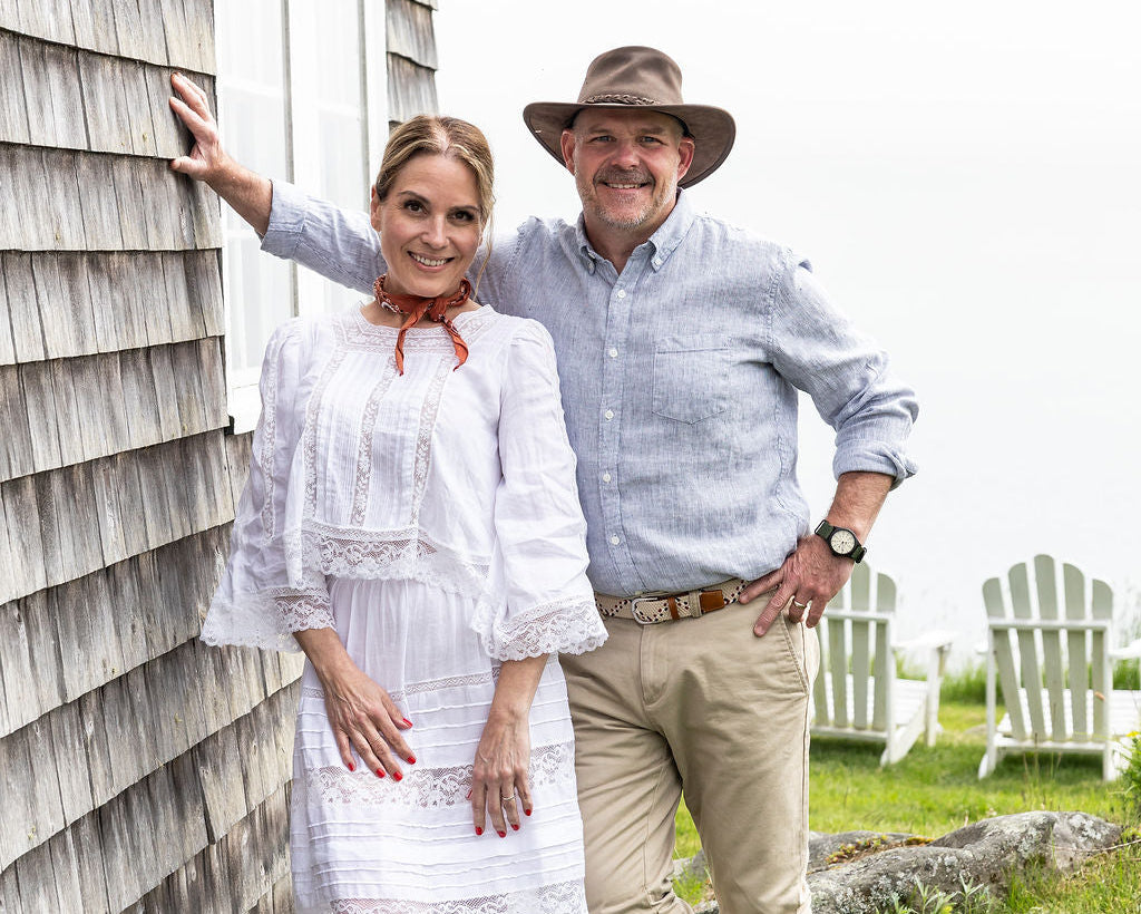 Mary and Rob, Farm + Sea co-founders, standing next to a beach house in Maine