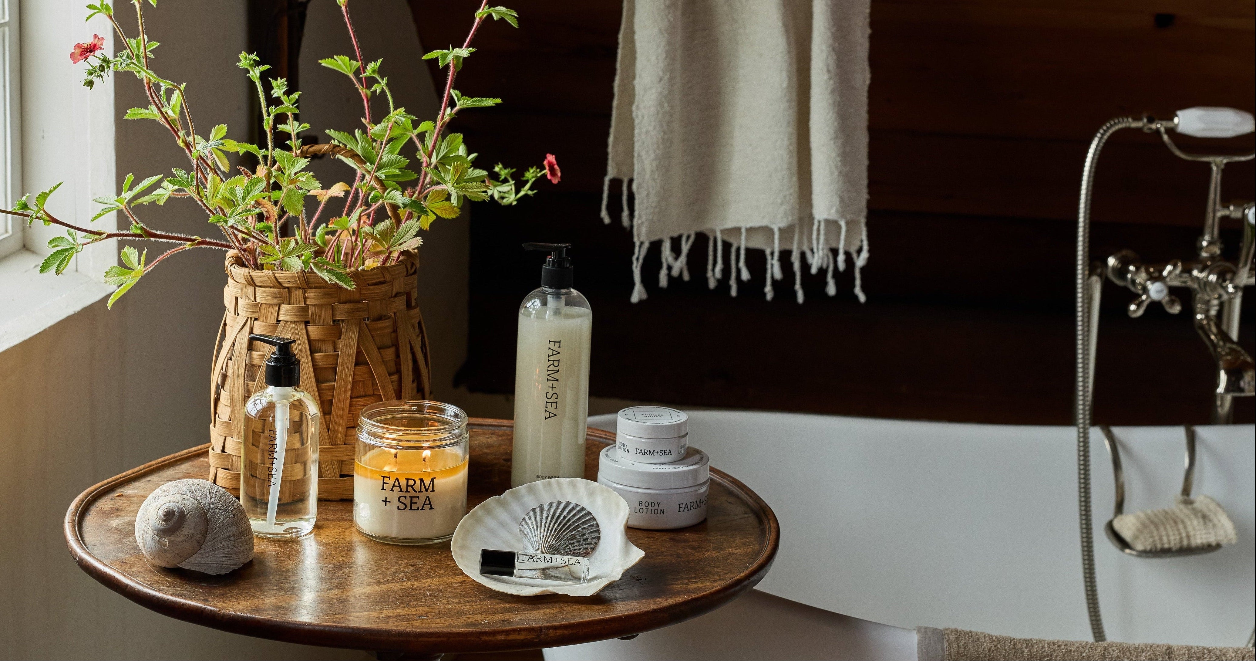 A number of Farm + Sea bath and boy products on a wooden table in a bathroom